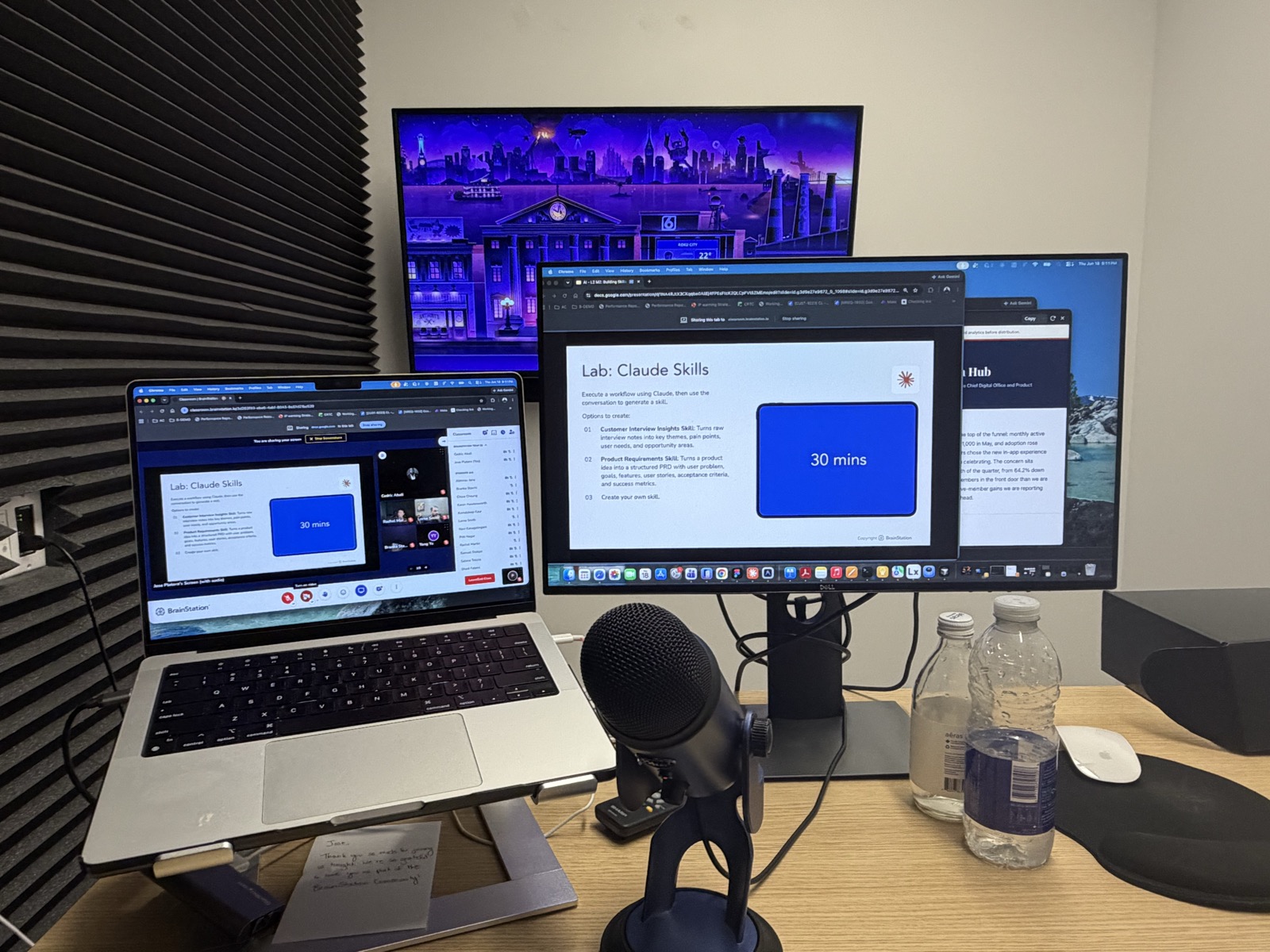 Jose's teaching rig: three screens running a live BrainStation AI certification lab
